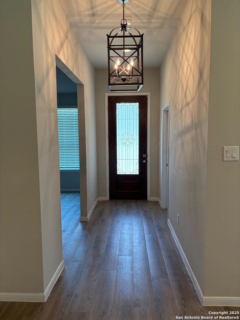 6358 Rolling Hills Road Conroe, TX 77303 - Photo 3 of 23 a view of a hallway with wooden floor and a window