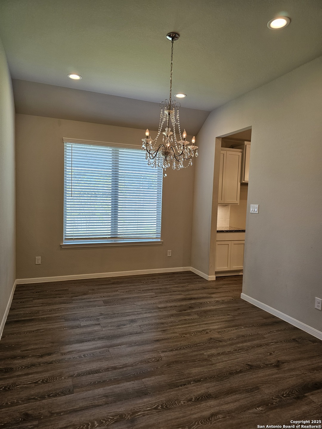 6358 Rolling Hills Road Conroe, TX 77303 - Photo 9 of 23 a view of an empty room with wooden floor and a window