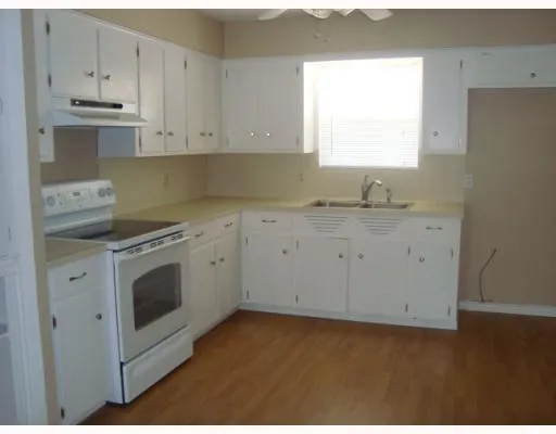 a view of a kitchen with sink and cabinets