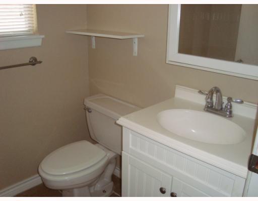 1019 Diomede Drive Portland, TX 78374 - Photo 5 of 7 a white toilet sitting next to a bathroom sink