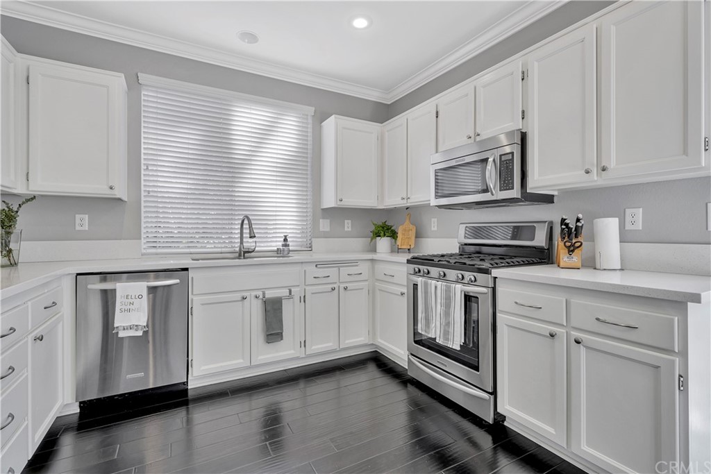 350 Exeter Way Corona, CA 92882 - Photo 52 of 56 a kitchen with stainless steel appliances granite countertop white cabinets a sink a stove a window and dishwasher
