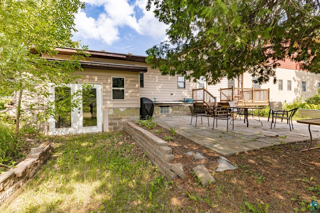 4800 Tower Road Moose Lake, MN 55767 - Photo 51 of 83 Expansive rear yard featuring a multi-level deck and a spacious stone patio
