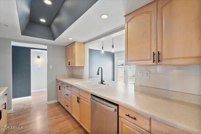 a large kitchen with kitchen island a sink stainless steel appliances and cabinets