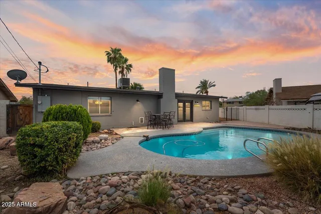 a view of a swimming pool with a patio