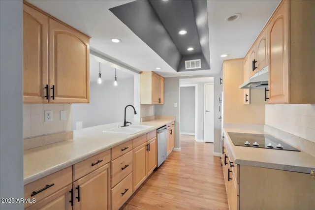 a kitchen with granite countertop a sink and cabinets