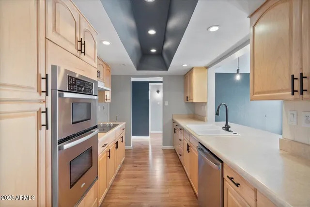 a large white kitchen with stainless steel appliances