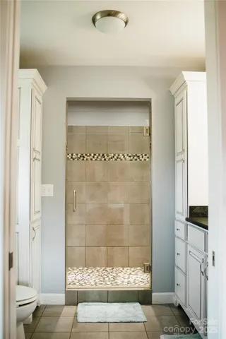 a bathroom with a glass shower door
