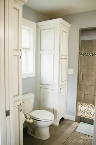 a white toilet sitting next to a bathroom sink