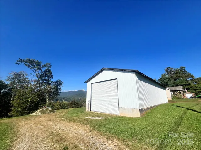 a view of a house with a yard and garage