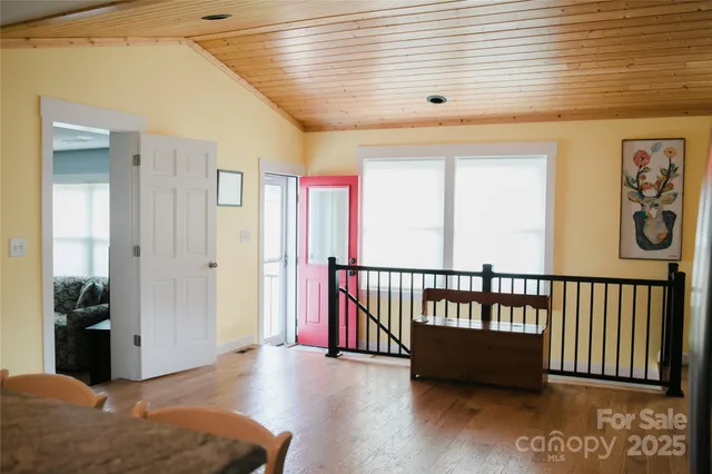 a view of a hallway with a large window and wooden floor