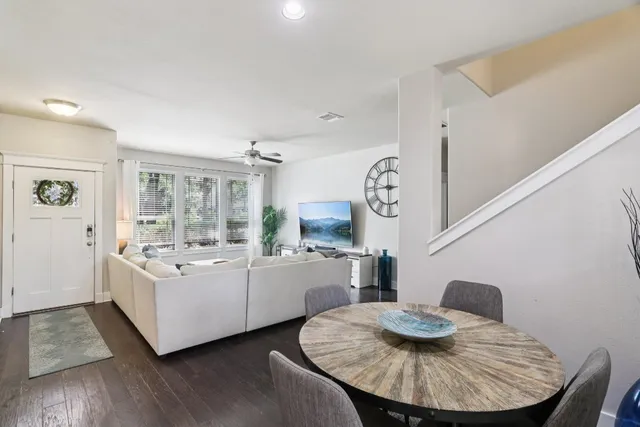 a living room with furniture and wooden floor