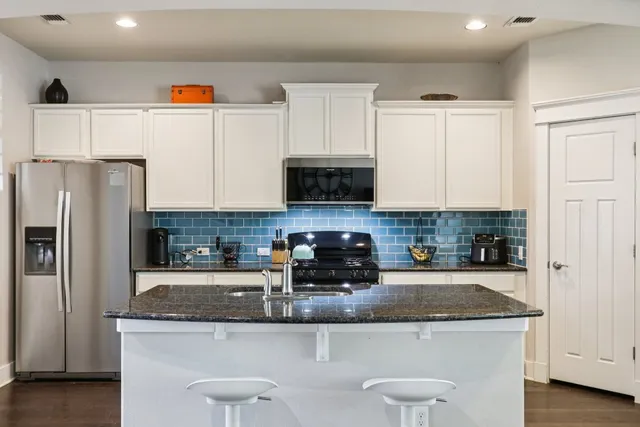 a kitchen with a stove and cabinets