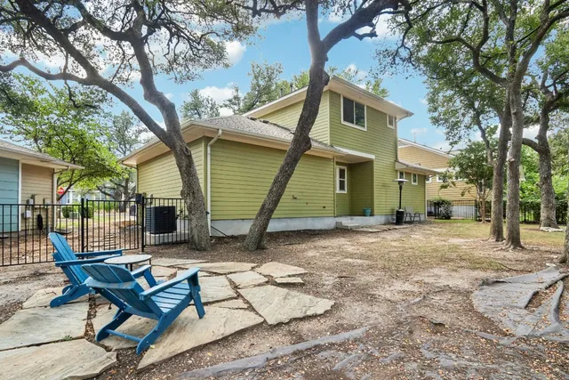 a view of house with backyard and outdoor seating