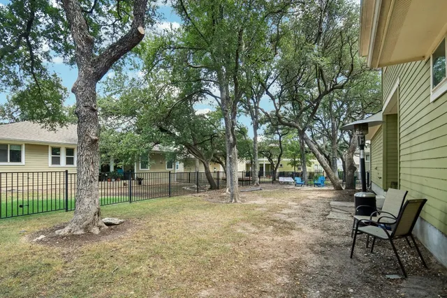 a view of a house with a backyard