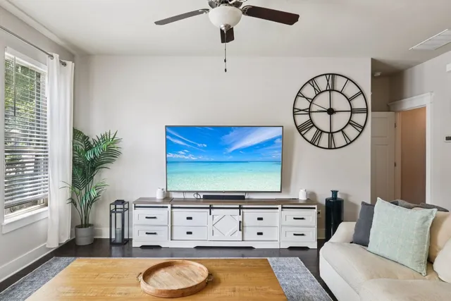 a living room with furniture and a flat screen tv
