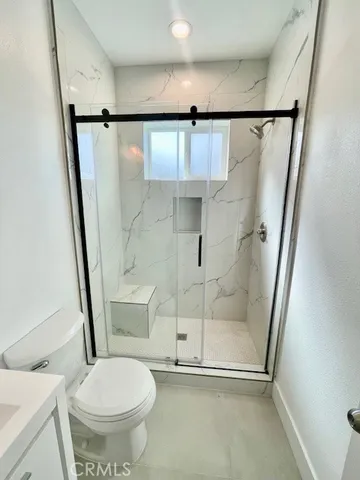 a bathroom with a shower and a toilet