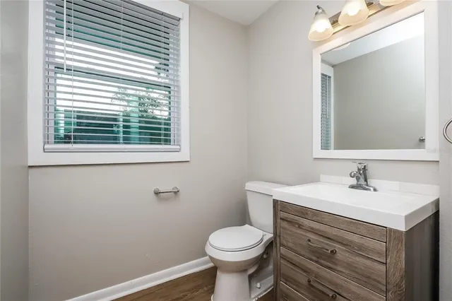 a bathroom with a sink toilet and mirror
