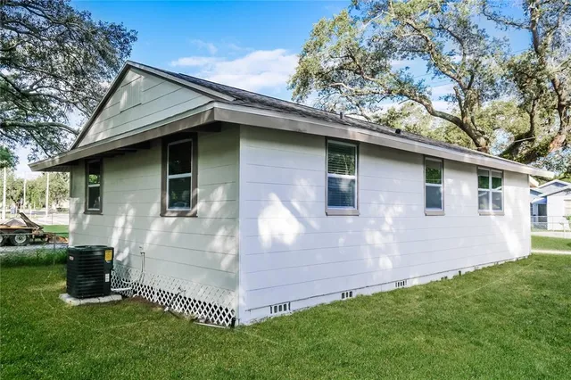 a backyard of a house with table and chairs