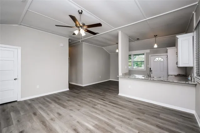 a view of a kitchen with a sink and a window