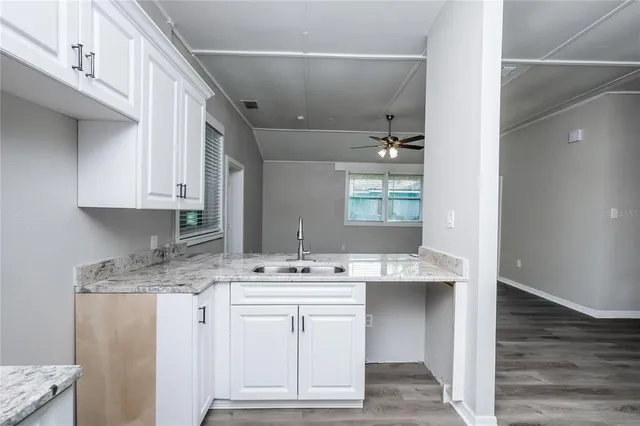 a kitchen with kitchen island a sink stainless steel appliances and cabinets