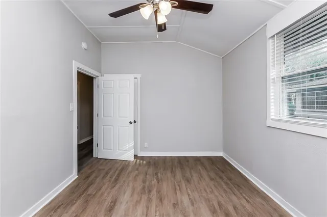 wooden floor in an empty room with a window
