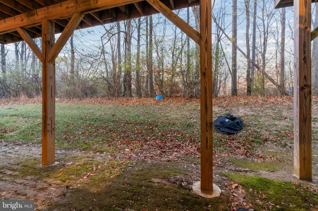 a view of a wooden door next to a yard