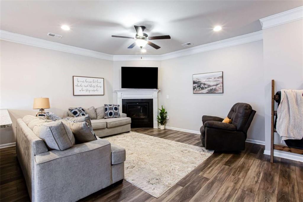 95 Bromes Street Lawrenceville, GA 30046 - Photo 11 of 37 a living room with furniture a fireplace and a flat screen tv
