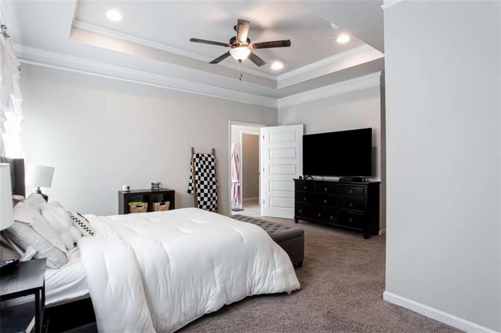 95 Bromes Street Lawrenceville, GA 30046 - Photo 17 of 37 a bedroom with a bed and a flat screen tv