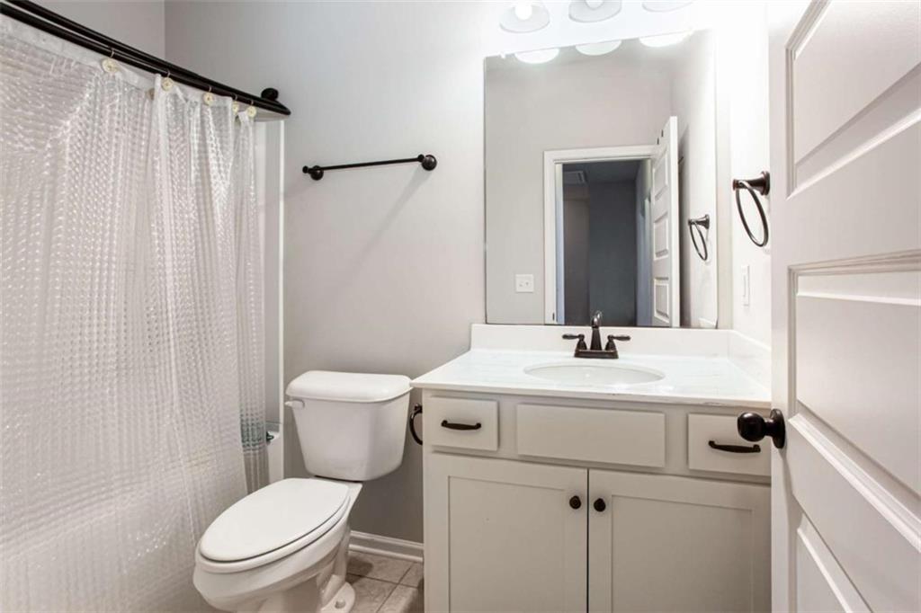 95 Bromes Street Lawrenceville, GA 30046 - Photo 23 of 37 a bathroom with a sink a toilet and shower