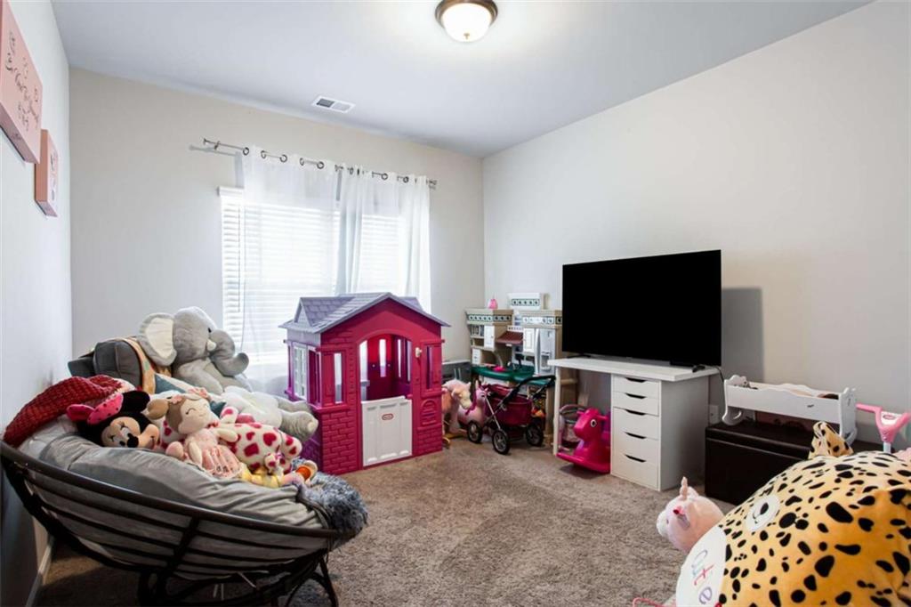 95 Bromes Street Lawrenceville, GA 30046 - Photo 27 of 37 a living room with furniture and a flat screen tv