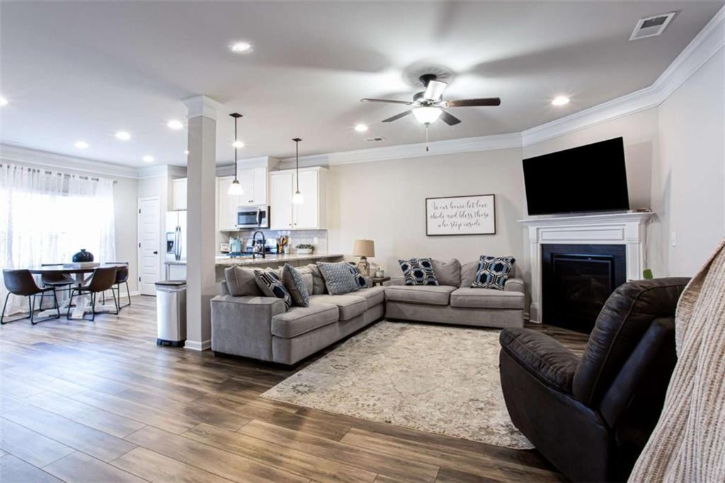 95 Bromes Street Lawrenceville, GA 30046 - Photo 10 of 37 a living room with furniture a fireplace and a flat screen tv
