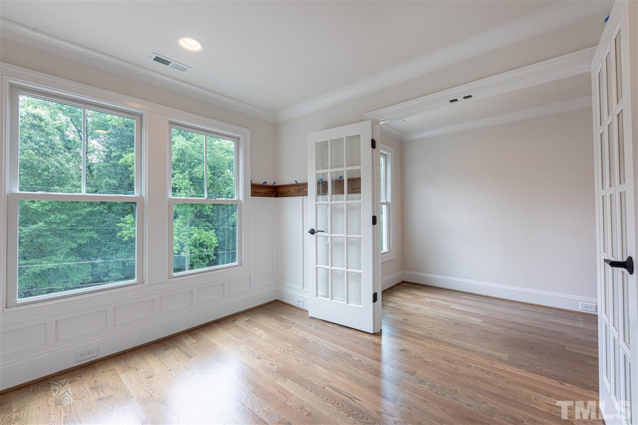 1439 Nottingham Road Raleigh, NC 27607 - Photo 18 of 23 an empty room with wooden floor and windows