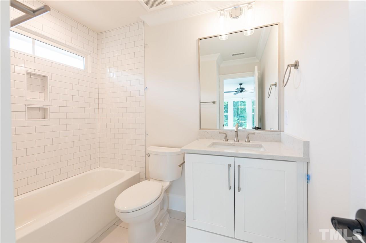 1439 Nottingham Road Raleigh, NC 27607 - Photo 21 of 23 a bathroom with a granite countertop toilet a sink and a bathtub