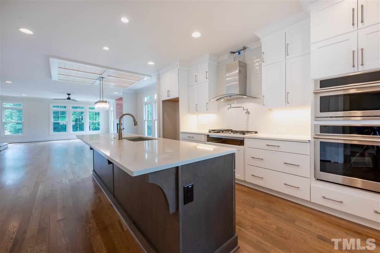 1439 Nottingham Road Raleigh, NC 27607 - Photo 5 of 23 a kitchen with stainless steel appliances granite countertop a sink a stove and a wooden floors