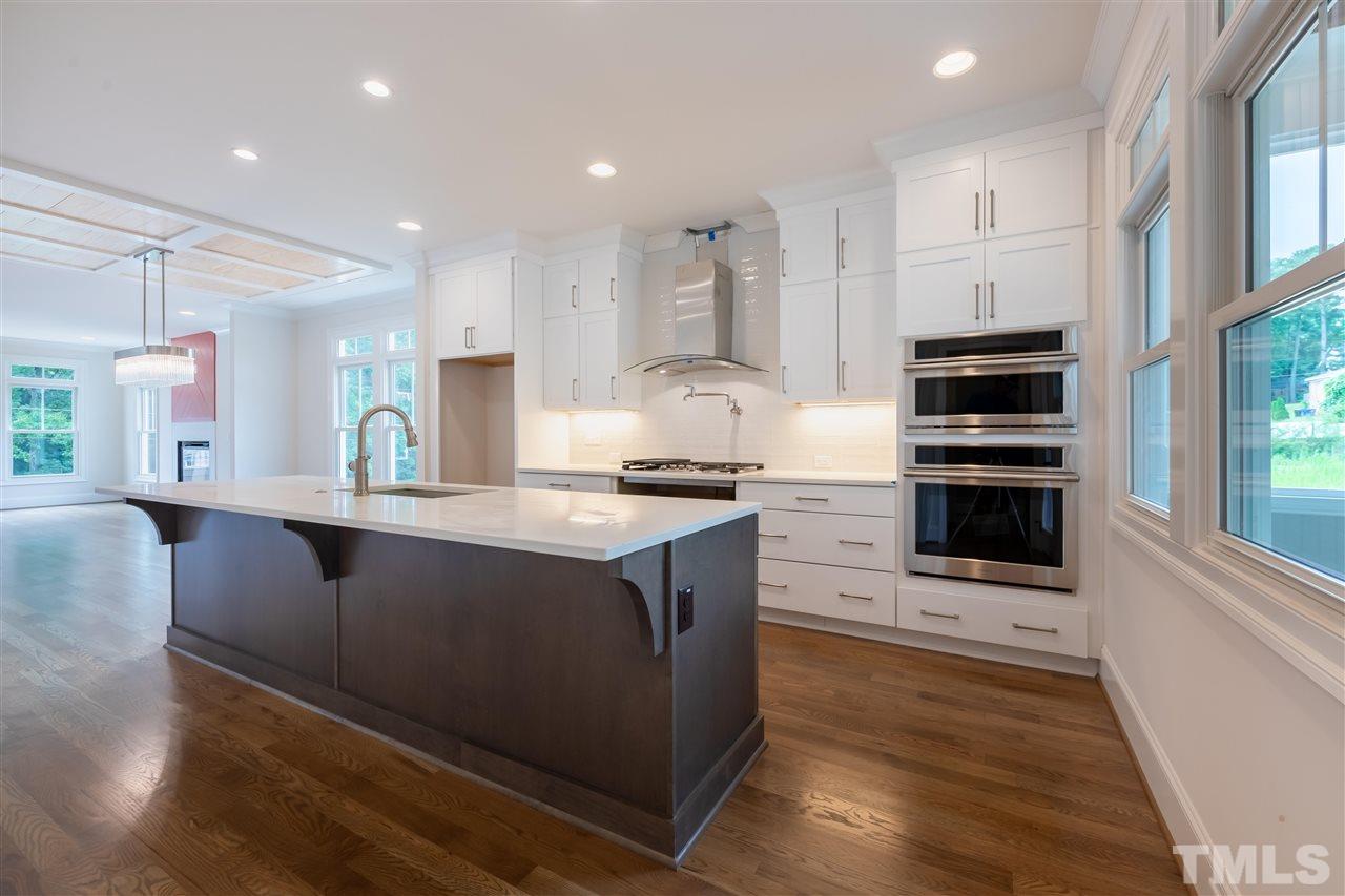 1439 Nottingham Road Raleigh, NC 27607 - Photo 7 of 23 a kitchen with stainless steel appliances kitchen island granite countertop a stove a sink and a refrigerator