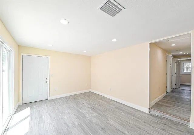 a view of hallway with wooden floor