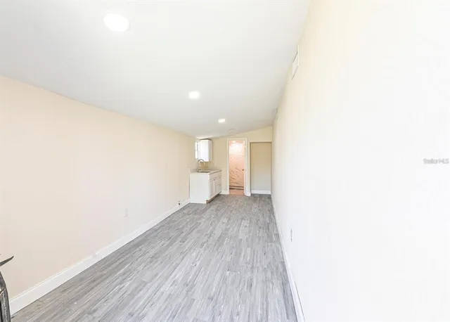a view of a room with wooden floor