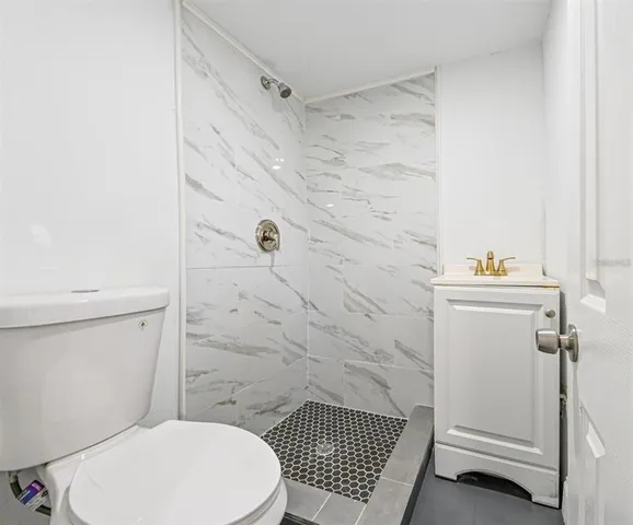 a bathroom with a toilet and a shower