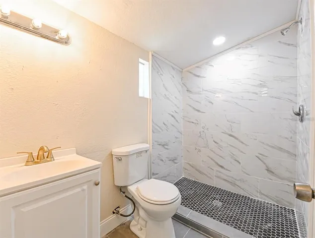 a bathroom with a toilet a sink and a shower