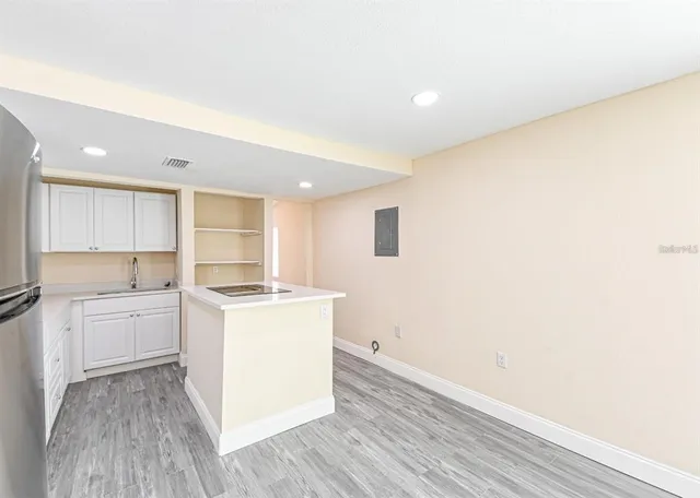 a kitchen with a stove a sink and a refrigerator