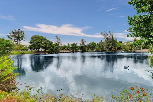 a view of a lake with a house in the background