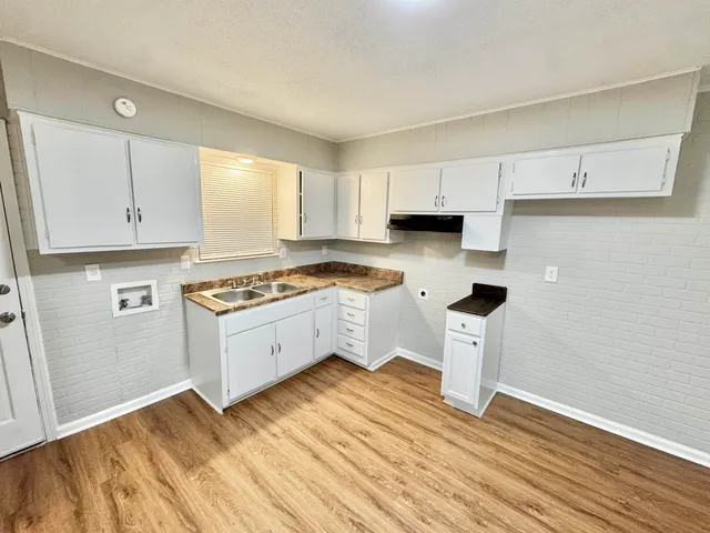 a kitchen with a sink and cabinets
