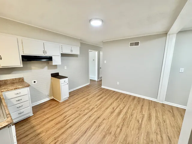 a view of kitchen and wooden floor