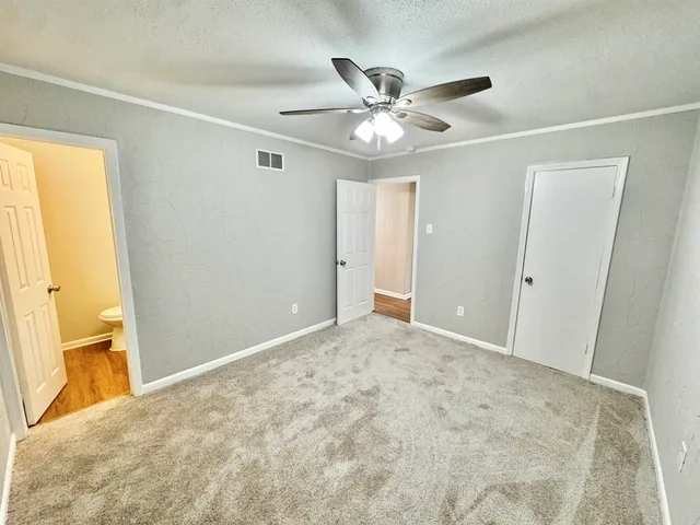 a view of a big room with wooden floor and windows in a room