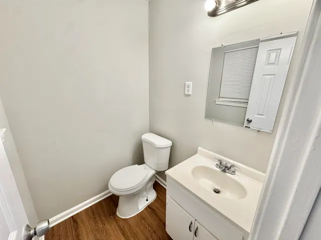a bathroom with a toilet sink and mirror