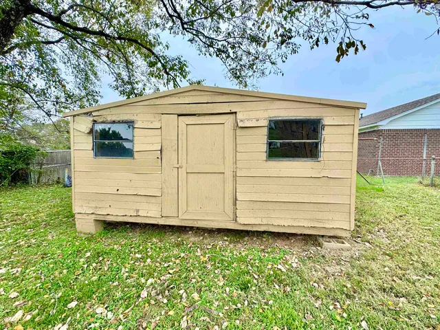 a view of a small house with a large window
