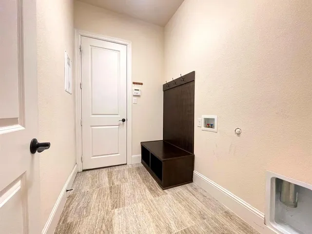 a view of a closet area with wooden floor