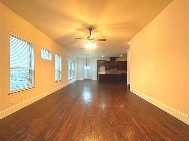 a view of a room window and wooden floor