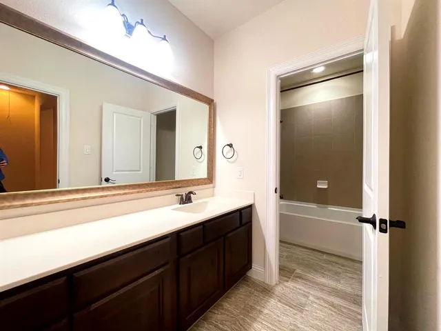 a bathroom with a double vanity sink and mirror with shower