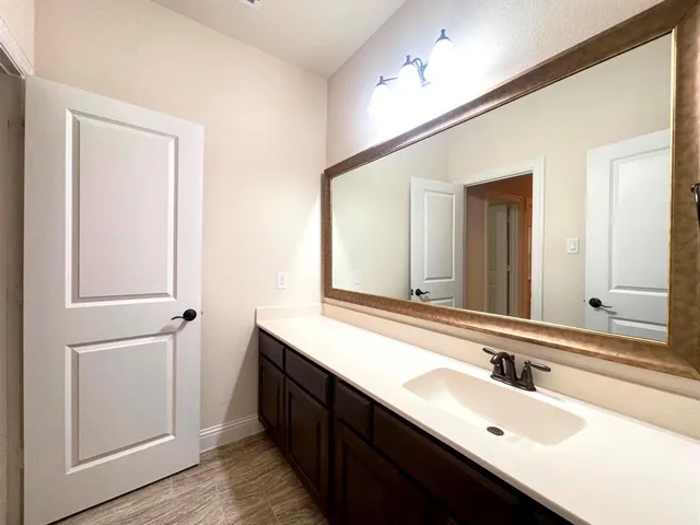 a bathroom with 2 sink and a mirror